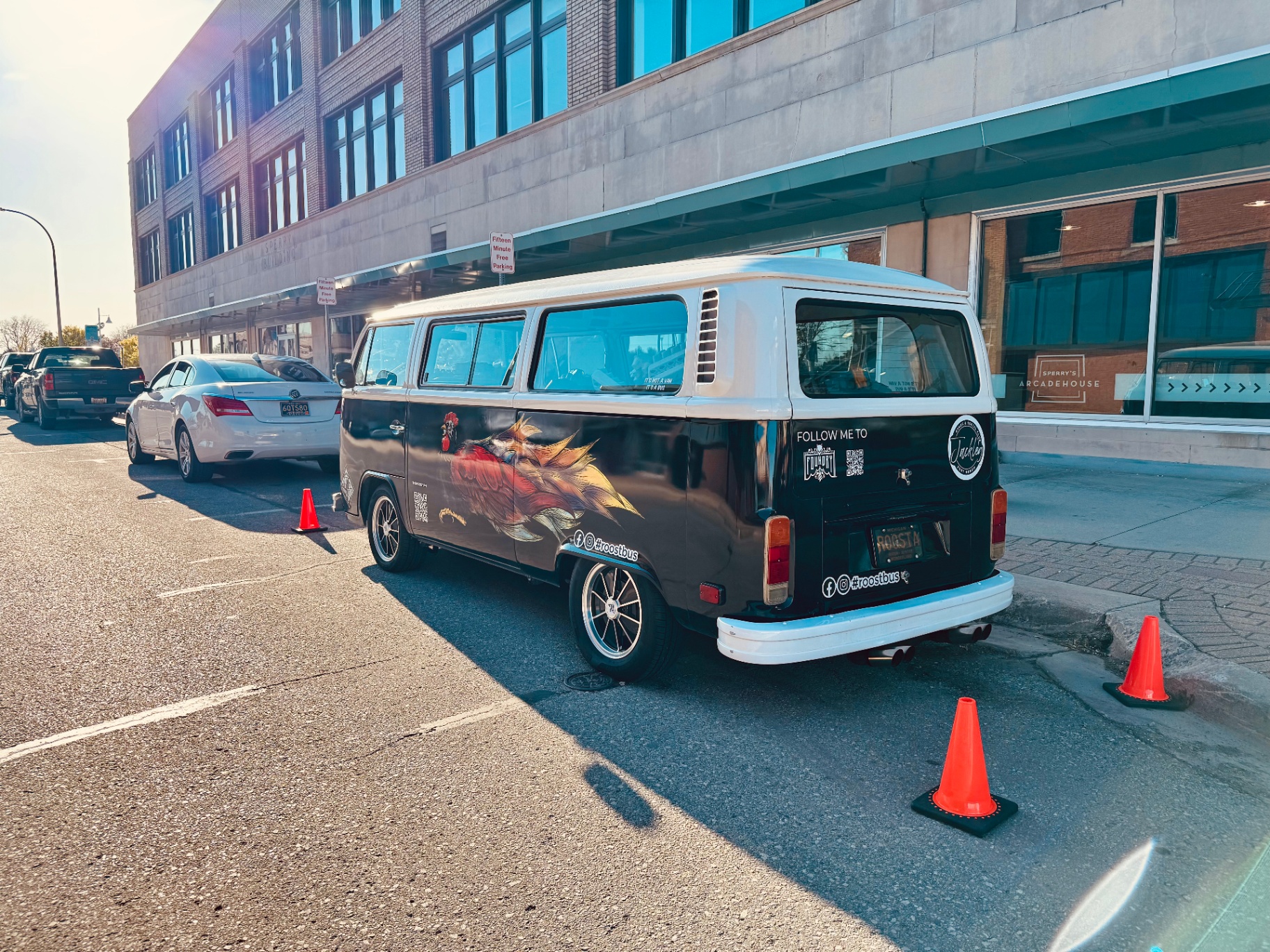 Roost Bus parked in front of a building with traffic cones around it